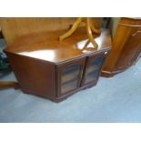 A MAHOGANY CORNER TELEVISION CABINET, WITH TWO GLAZED DOORS AND A SMALL HARDWOOD EASY ARMCHAIR,