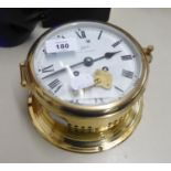 A ROYAL MARINER BRASS PORT HOLE CLOCK