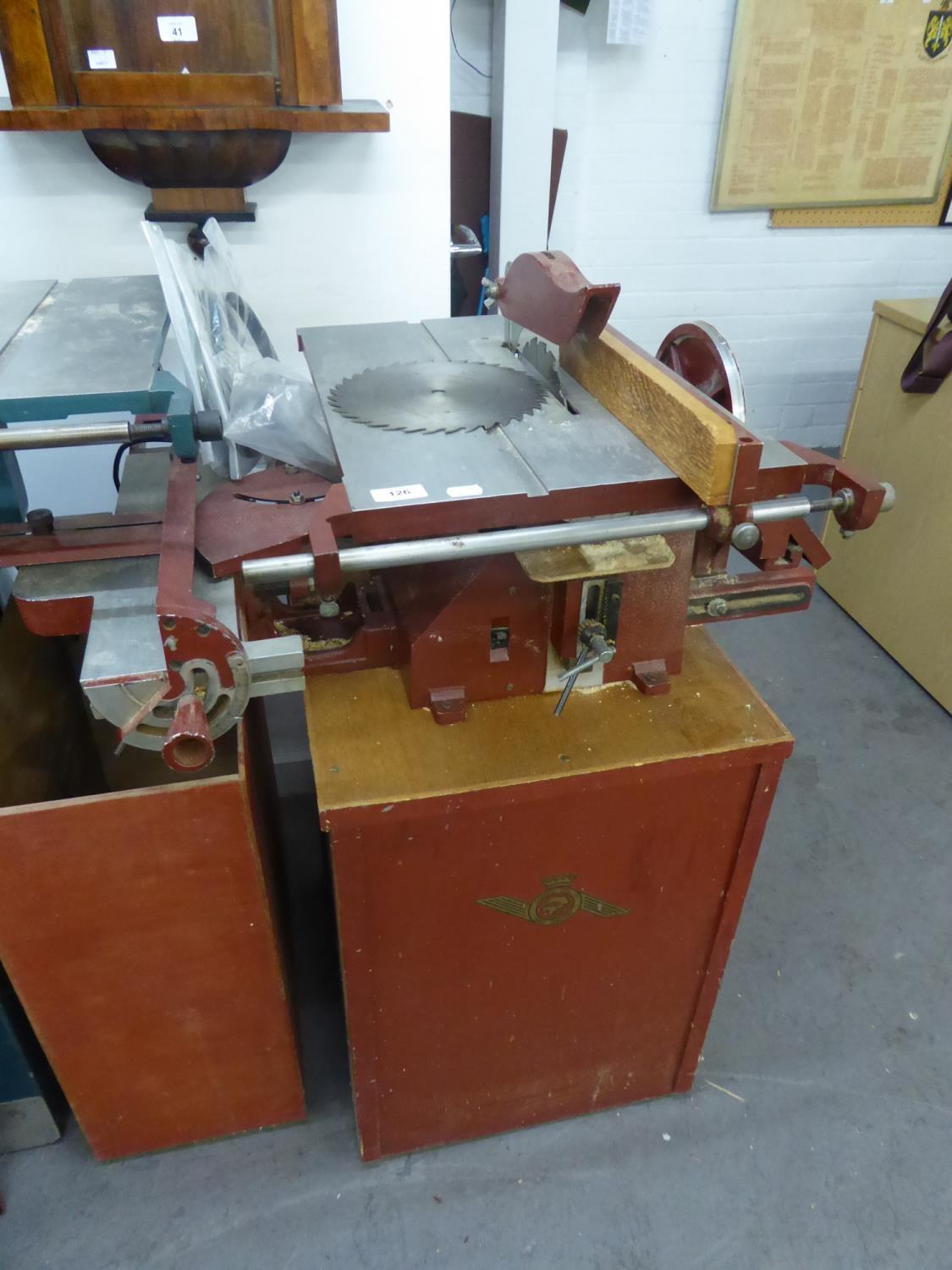 A CORONET TOIL AND CO., LARGE ELECTRIC CIRCULAR SAW, ON WOODEN CUPBOARD STAND