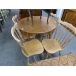 A DROP LEAF KITCHEN TABLE AND 4 CHAIRS