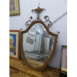 A SHIELD SHAPED GILT FRAMED WALL MIRROR (IN NEED OF RESTORATION)