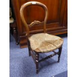 NINETEENTH CENTURY CARVED WALNUT CHILD'S RUSH SEATED BALLOON BACK CHAIR, of typical form with