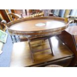 MODERN WHITE METAL BANDED MAHOGANY TWO HANDLED OVAL BUTLER'S TRAY ON STAND, the galleried tray