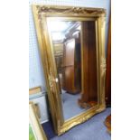 MODERN BEVEL EDGED OBLONG WALL MIRROR, in swept gilt frame with pierced scroll corners, 34 1/4" x