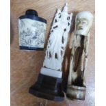 ORIENTAL IVORY AND BLACK WOOD SNUFF BOTTLE and two other MARINE IVORY AND BONE OBJECTS (3)