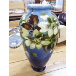 EARLY 1900s LEEDS POTTERY OVOID VASE, slip decorated with flowers on a dark shading to lighter