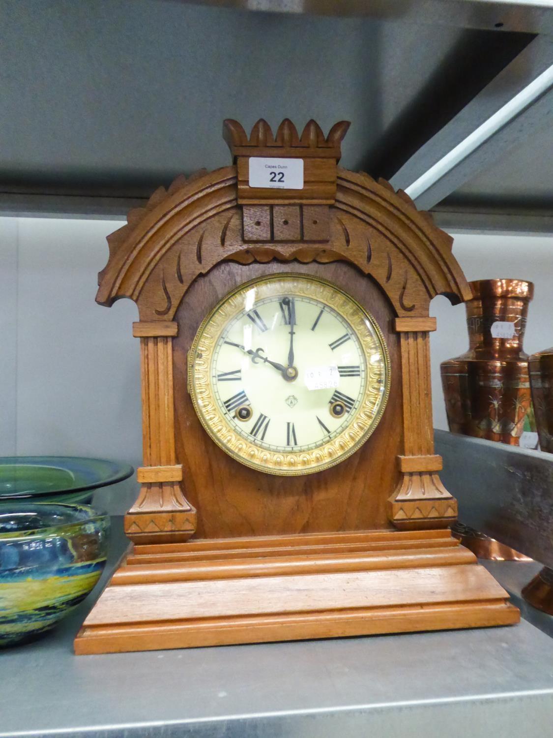 A WALNUTWOOD MANTEL CLOCK