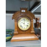 A WALNUTWOOD MANTEL CLOCK