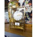 A 'KUNDO' BRASS AND GLASS MANTEL CLOCK