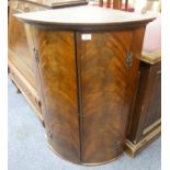GEORGIAN FLAME CUT MAHOGANY BOW FRONTED CORNER CUPBOARD, of typical form with exposed brass H hinges