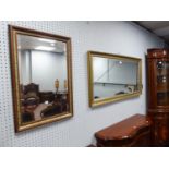 A LARGE GILT FRAMED OBLONG WALL MIRROR AND A SMALLER OBLONG MIRROR (2)