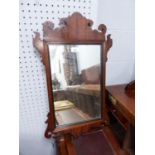 NINETEENTH CENTURY FIGURED MAHOGANY WALL MIRROR, the oblong plate within a moulded frame with scroll