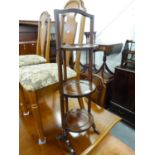 A MAHOGANY THREE TIER FOLDING CAKE STAND ON CHEVAL SUPPORTS