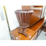 A MAHOGANY SLATTED WOOD JARDINIERE, CIRCULAR ON TRIPOD BASE