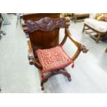 AN ORIENTAL CARVED MAHOGANY 'X' FRAMED ARMCHAIR