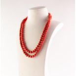 VICTORIAN TWO STRAND NECKLACE, of barrel shaped coral beads, knotted strung, the gold oblong clasp