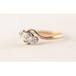 9ct GOLD AND PLATINUM CROSS-OVER RING with three small diamonds in deceptive settings, approximately
