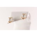 A pair of 18ct gold aquamarine and diamond earrings. Each designed as a rectangular shape aquamarine