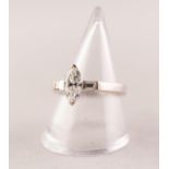 A diamond solitaire ring. The marquise shape diamond with baguette cut diamond shoulders,