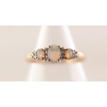 9ct GOLD OPAL AND TINY DIAMOND RING set with centre oval opal flanked by two smaller opals and ten