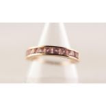 9ct GOLD HALF ETERNITY RING channel set with nine circular pink spinels, 2.4 gms, ring size P