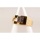 18ct GOLD RING with a square raised setting set with four tiny diamonds, chased bark pattern