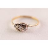 18ct GOLD AND PLATINUM CROSS-OVER RING with three tiny diamonds in deceptive settings, 1.3gms,