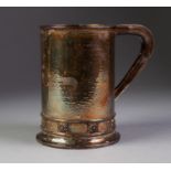 GEORGE V ARTS AND CRAFTS PLANISHED SILVER TYANKARD BY A.E. JONES, of slightly tapering form with