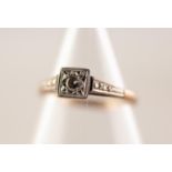 9ct GOLD AND PLATINUM RING WITH A SOLITAIRE ROUND BRILLIANT CUT DIAMOND in a pave square setting,