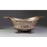 UNMARKED EMBOSSED AND PIERCED FOREIGN SILVER COLOURED METAL TWO HANDLED DISH, of oval form with