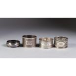 THREE SILVER NAPKIN RINGS, one engine turned, and another floral engraved, all inscribed, 1.5oz,