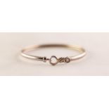9ct WHITE GOLD BANGLE with hook and wire pattern loop fastener, set with a smal,l round, brilliant