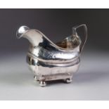 A WILLIAM IV IRISH SILVER CREAM JUG, engraved borders and two oblong opposing cartouches, one