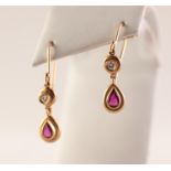 PAIR OF 9ct GOLD DROP EARRINGS FOR PIERCED EARS, each with a circular drop with a small diamond in a