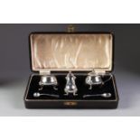 A CASED PRE-WAR SILVER THREE PIECE CONDIMENT SET, the salt cellar and mustard pot with blue glass