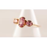 9ct GOLD RING SET WITH CENTRE OVAL golden spinel flanked by two smaller circular golden spinels 1.