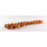 A NECKLACE FORMED OF 26 AMBER GRADUATED BEADS