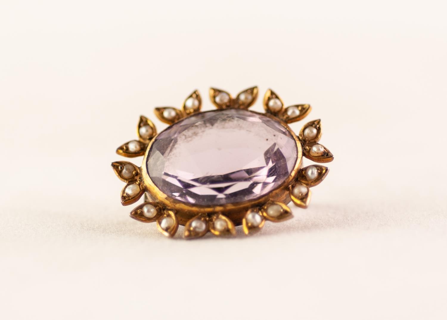 VICTORIAN BROOCH SET WITH A LARGE OVAL AMETHYST and foliate surround set with seed pearls, 1" (2.