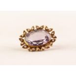 VICTORIAN BROOCH SET WITH A LARGE OVAL AMETHYST and foliate surround set with seed pearls, 1" (2.
