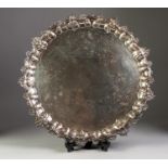 GEORGE IV SILVER CIRCULAR TRAY, chased and repousse with flowers, fruit and rococo scrolls, the