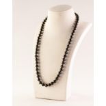 CHINESE SINGLE STRAND NECKLACE of uniform black freshwater pearls with 14k gold clasp, 18" long,
