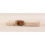 THREE STRAND BRACELET OF UNIFORM CULTURE PEARLS with whit gold oblong clasp set with and oblong