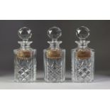 SET OF THREE SILVER SPIRIT LABELS Brandy, Whisky and Gin oblong, the borders repousse with rococo