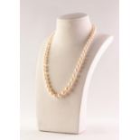 SINGLE STRAND NECKLACE OF FIFTY EIGHT GRADUATED NATURAL PEARLS the clasp collar set with a centre