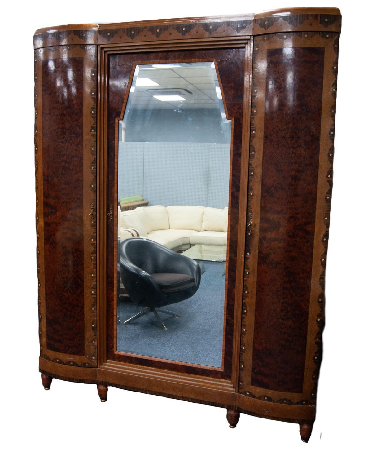 A FINE QUALITY FRENCH INTER-WAR YEARS WARDROBE, having a centre bevelled mirrored door flanked by