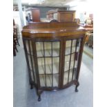 AN EARLY TWENTIETH CENTURY MAHOGANY BOW FRONTED DISPLAY CABINET, RAISED ON CLAW AND BALL FEET