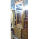 AN OAK TALL GLAZED DOOR CABINET ON THREE DRAWER BASE