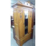 AN EARLY TWENTIETH CENTURY BEECHWOOD SINGLE DOOR WARDROBE ON SINGLE DRAWER BASE