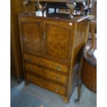 A FIGURED WALNUT MILLINERY CABINET WITH A TWO DOOR CUPBOARD OVER THREE LONG DRAWERS