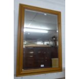 A RECTANGULAR PINE FRAMED WALL MIRROR